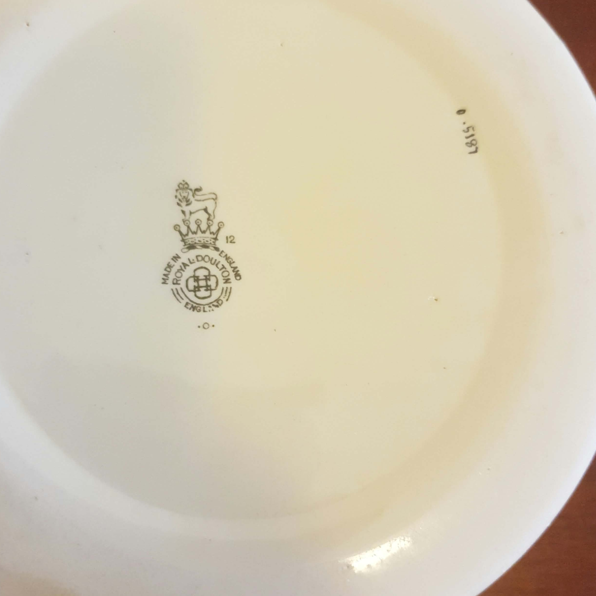 The underside of a white ceramic plate or bowl, showing a printed Royal Albert England crest and maker's mark in the center, with a small code '8.5191' on the right side.
